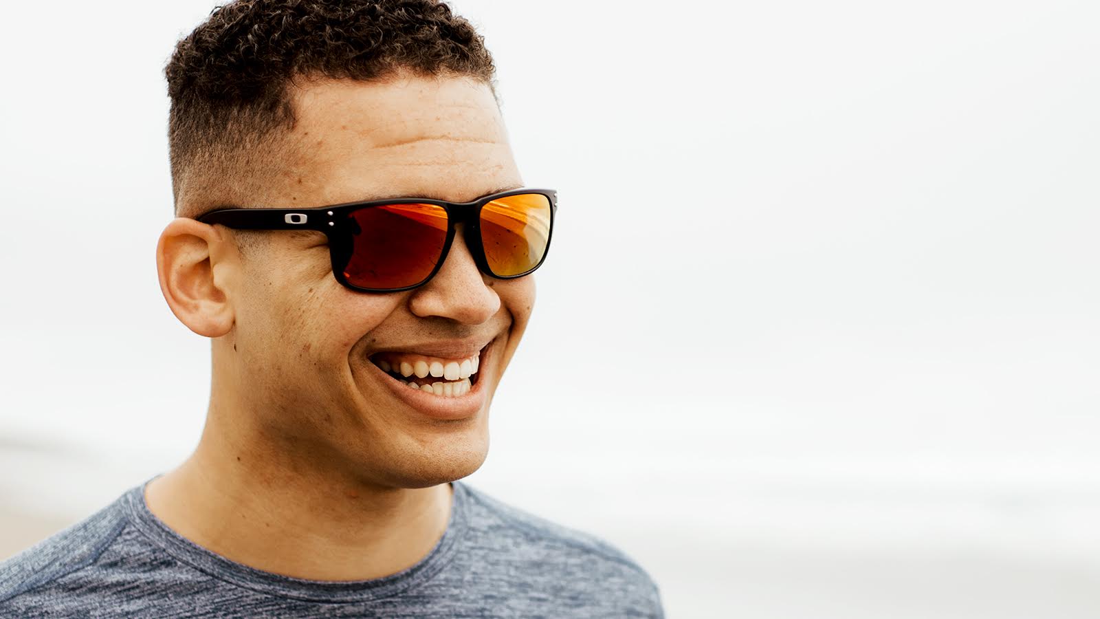 Man smiling with sunglasses on his face