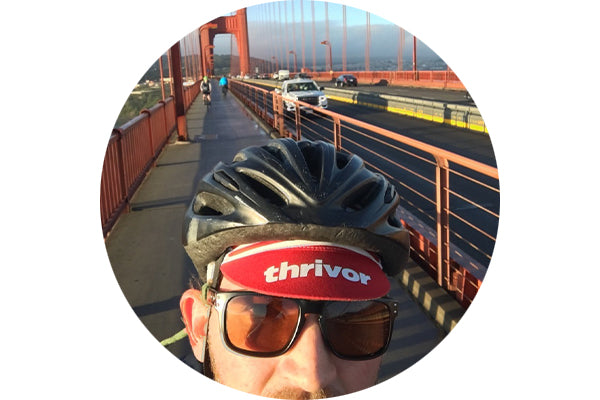 selfie view of a road biker wearing dark brown lenses with the golden gate bridge in the background