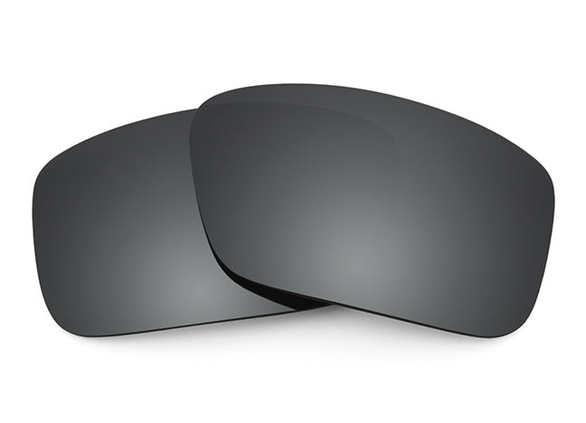 Two Black Chrome mirrored Sunglass lenses laid on top of each other.