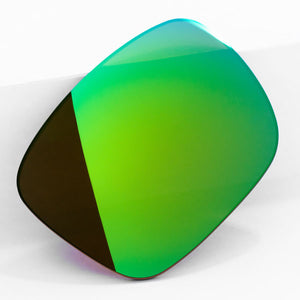 One Emerald Green sunglass lens with mirrorshield leaning on a white wall.