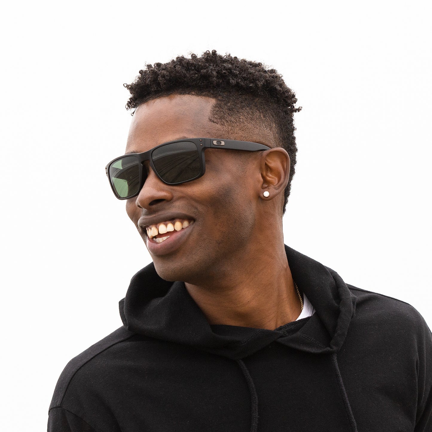 A person wearing sunglasses with Non-Polarized Gray Green lenses installed in the frame