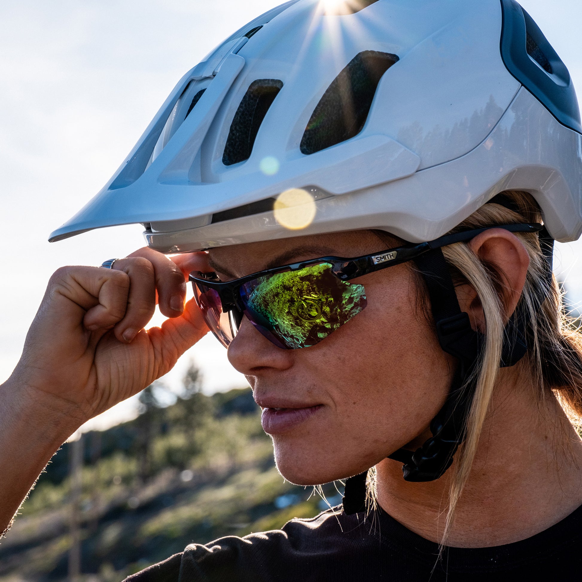 a person wearing sunglasses with borealis green lenses