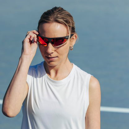 a person wearing sunglasses with ember red lenses