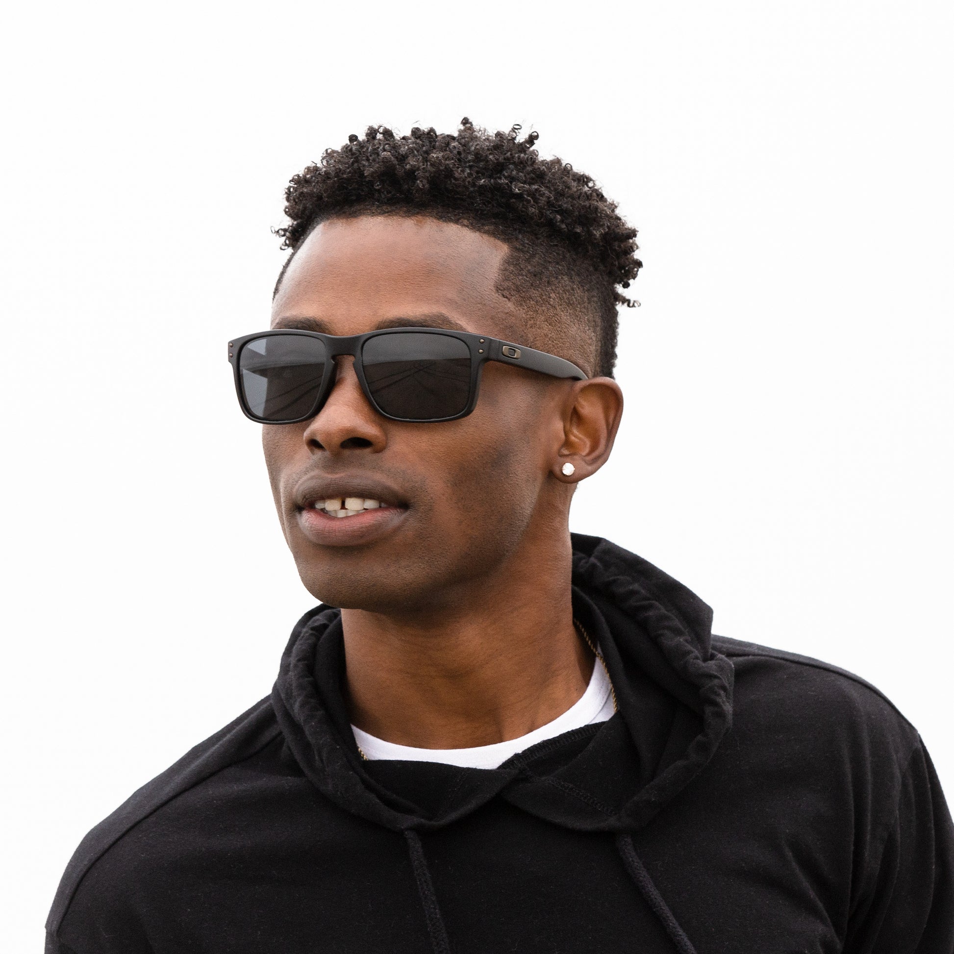 A person wearing sunglasses with Non-Polarized Adapt Gray Photochromic lenses installed in the frame