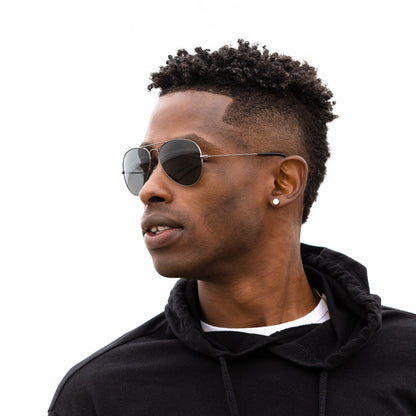 A person wearing sunglasses with Polarized Black Chrome lenses installed in the frame