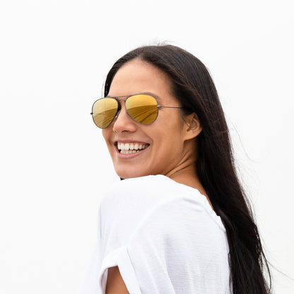 A person wearing sunglasses with Polarized Flare Gold lenses installed in the frame