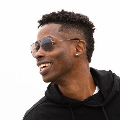 A person wearing sunglasses with Polarized Flash Bronze lenses installed in the frame