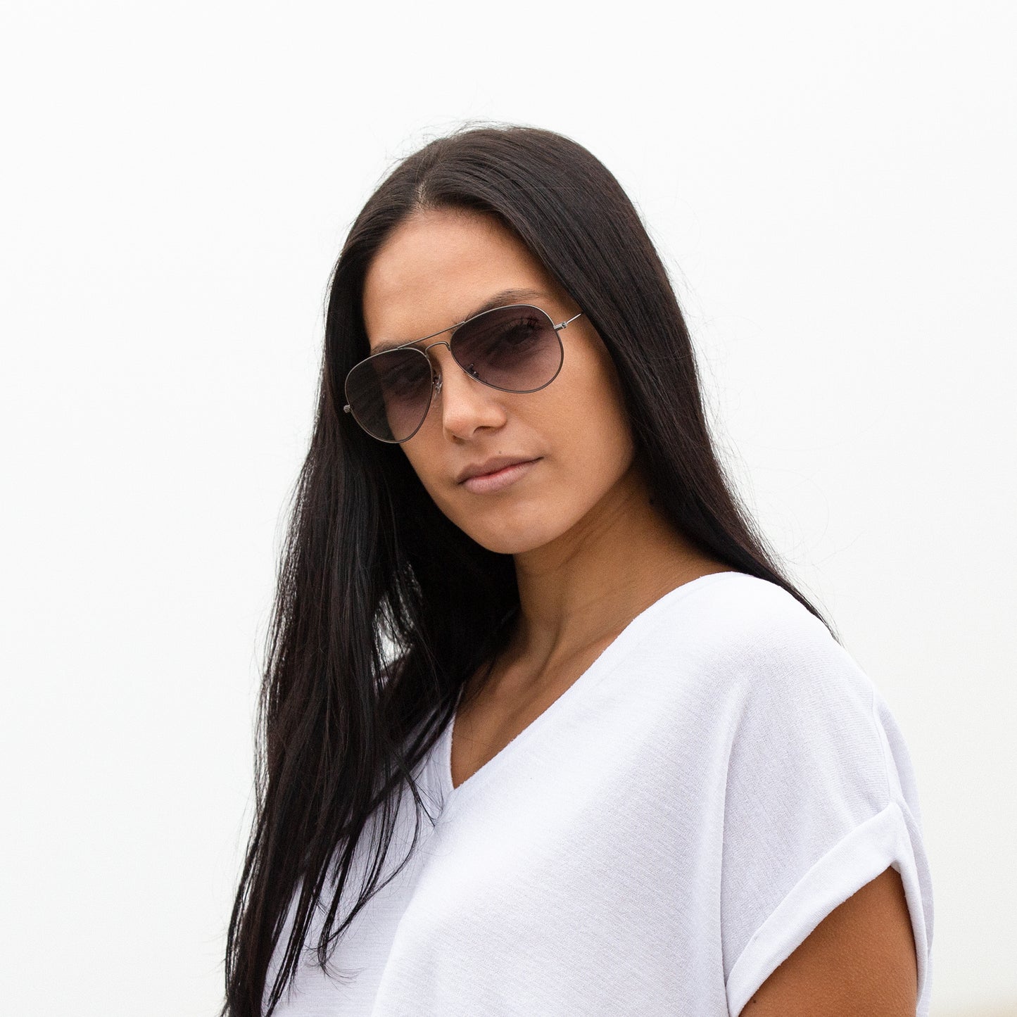 A person wearing sunglasses with Non-Polarized Gray Gradient lenses installed in the frame