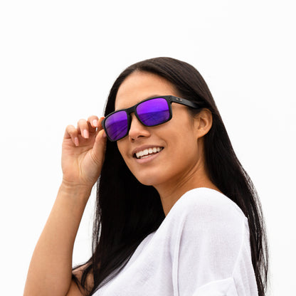 A person wearing sunglasses with Polarized Plasma Purple lenses installed in the frame